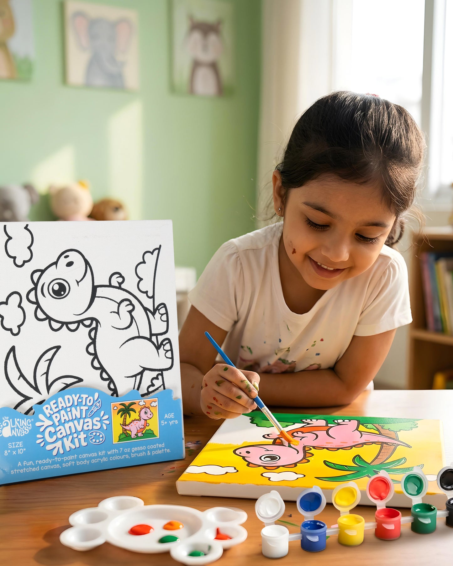 Child painting the Dinosaur Ready-to-Paint Canvas Kit 8×10 using acrylic paints to create a colourful dinosaur artwork with palm tree scene.