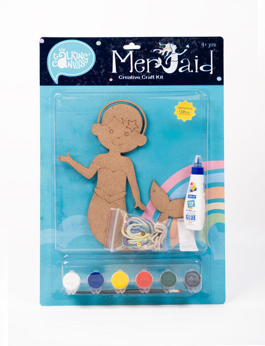 Front of The Talking Canvas Mermaid Creative Craft Kit with MDF mermaid cutout, yarn, glue, brush and 6 acrylic paint pots in blue packaging.
