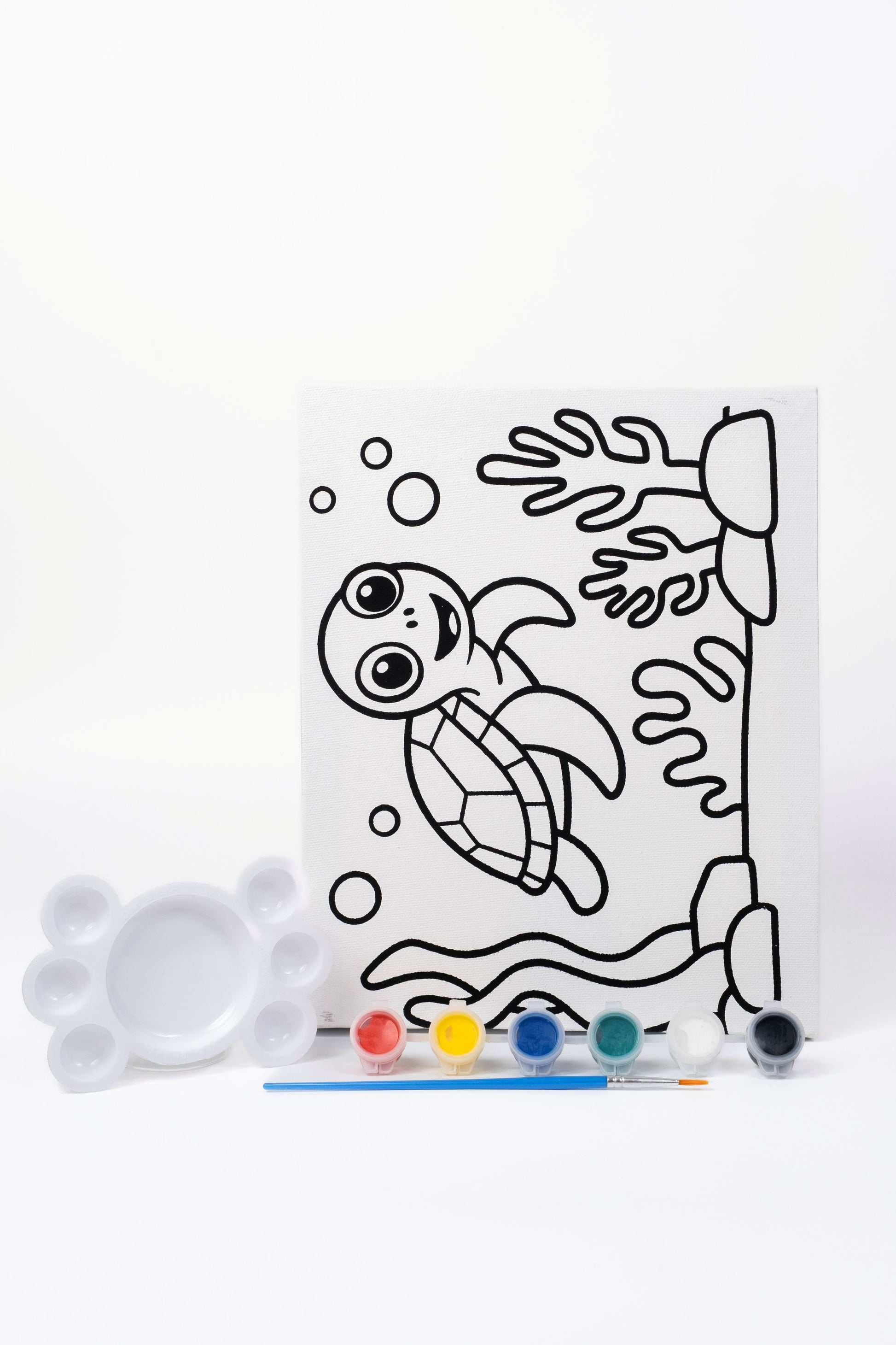 Ready-to-Paint Canvas Kit – Tortoise 8×10 with pre-printed canvas, acrylic paints, paint brush and paint palette on display.