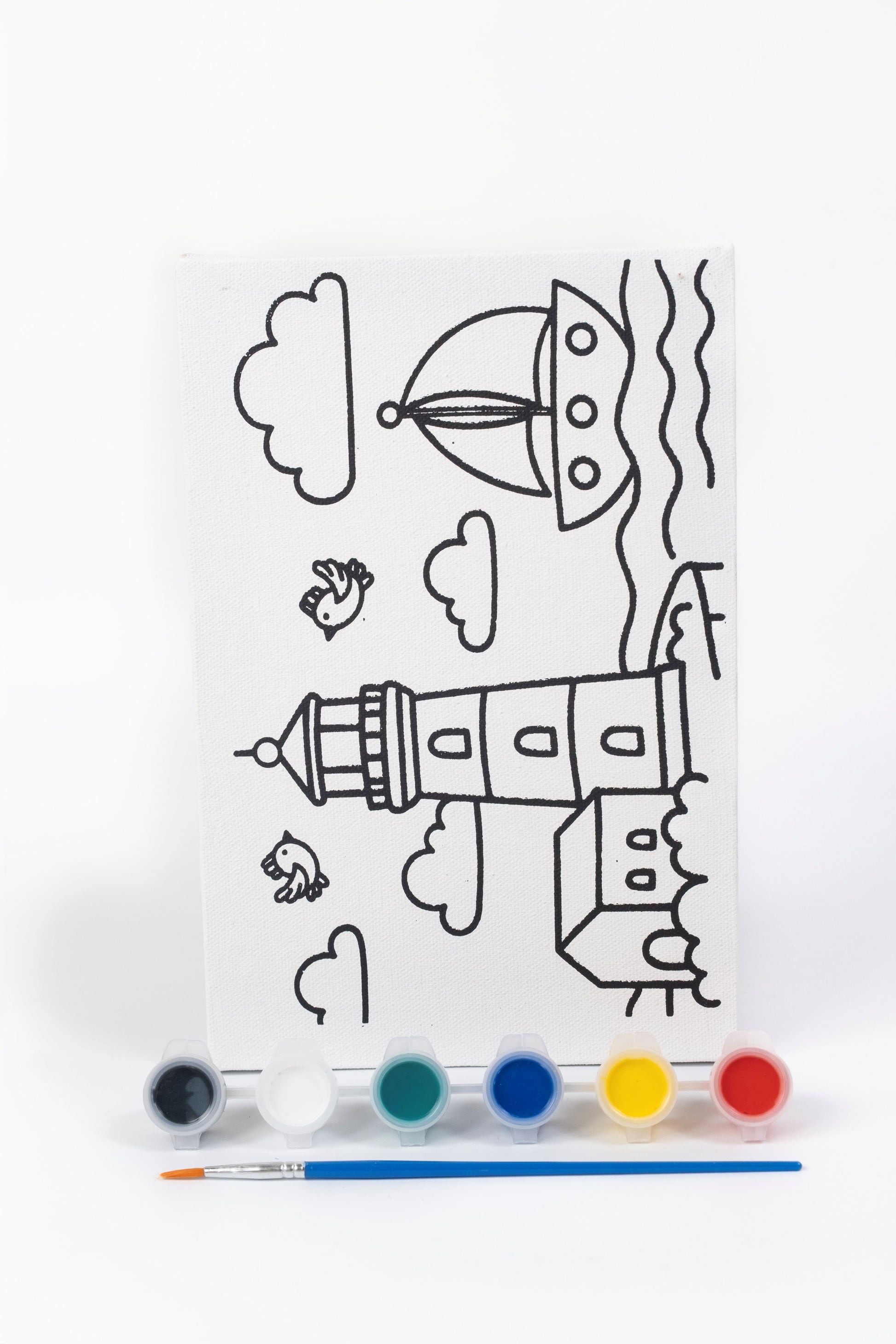 Lighthouse Ready-to-Paint Canvas Kit 6×9 with pre-printed lighthouse canvas, acrylic paint pots, paint brush and seaside artwork on white background.