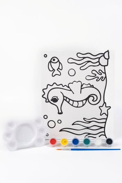 Seahorse Ready-to-Paint Canvas Kit 8×10 with pre-printed seahorse canvas, acrylic paint pots, paint brush and palette on white background.