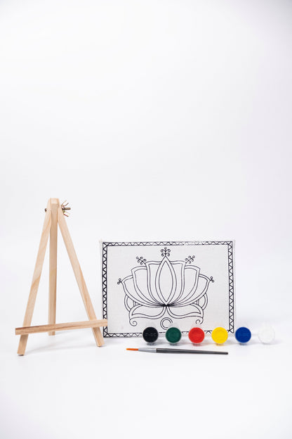 Contents of The Talking Canvas Madhubani Lotus Canvas Wall Art DIY Kit with outlined lotus canvas, wooden easel, brush and 6 acrylic paint pots.