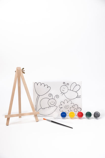 Contents of The Talking Canvas Garden Canvas Painting Kit including pre-printed garden canvas, wooden easel stand, paints and paint brush.