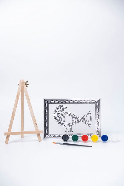 Contents of The Talking Canvas Madhubani Peacock Canvas Wall Art DIY Kit with outlined peacock canvas, wooden easel, brush and 6 acrylic paint pots.