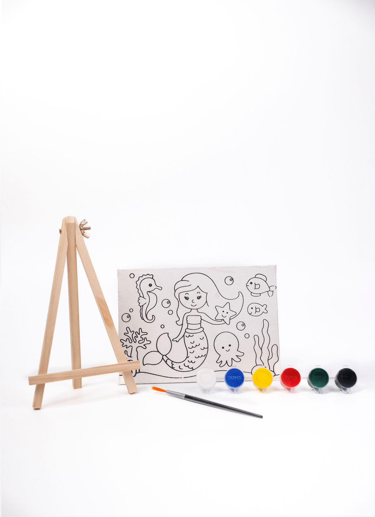 Contents of The Talking Canvas Mermaid Canvas Painting Kit including pre-printed canvas, wooden easel stand, paints and paint brush.