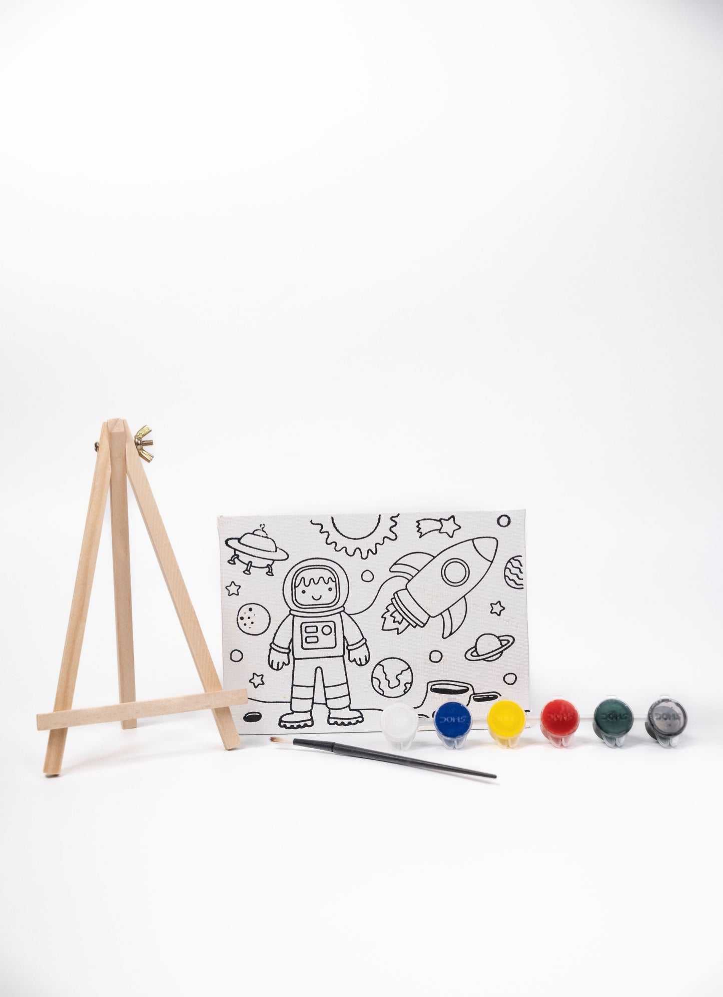 Space Canvas Painting Kit contents featuring a pre-printed space canvas, wooden easel, six acrylic paint pots and paint brush on a white background.