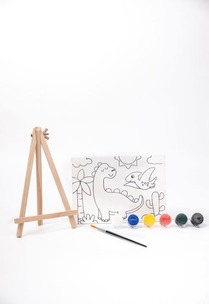 Dinosaur Canvas Painting Kit contents featuring a pre-printed dinosaur canvas, wooden easel, six acrylic paint pots and paint brush on a white background.