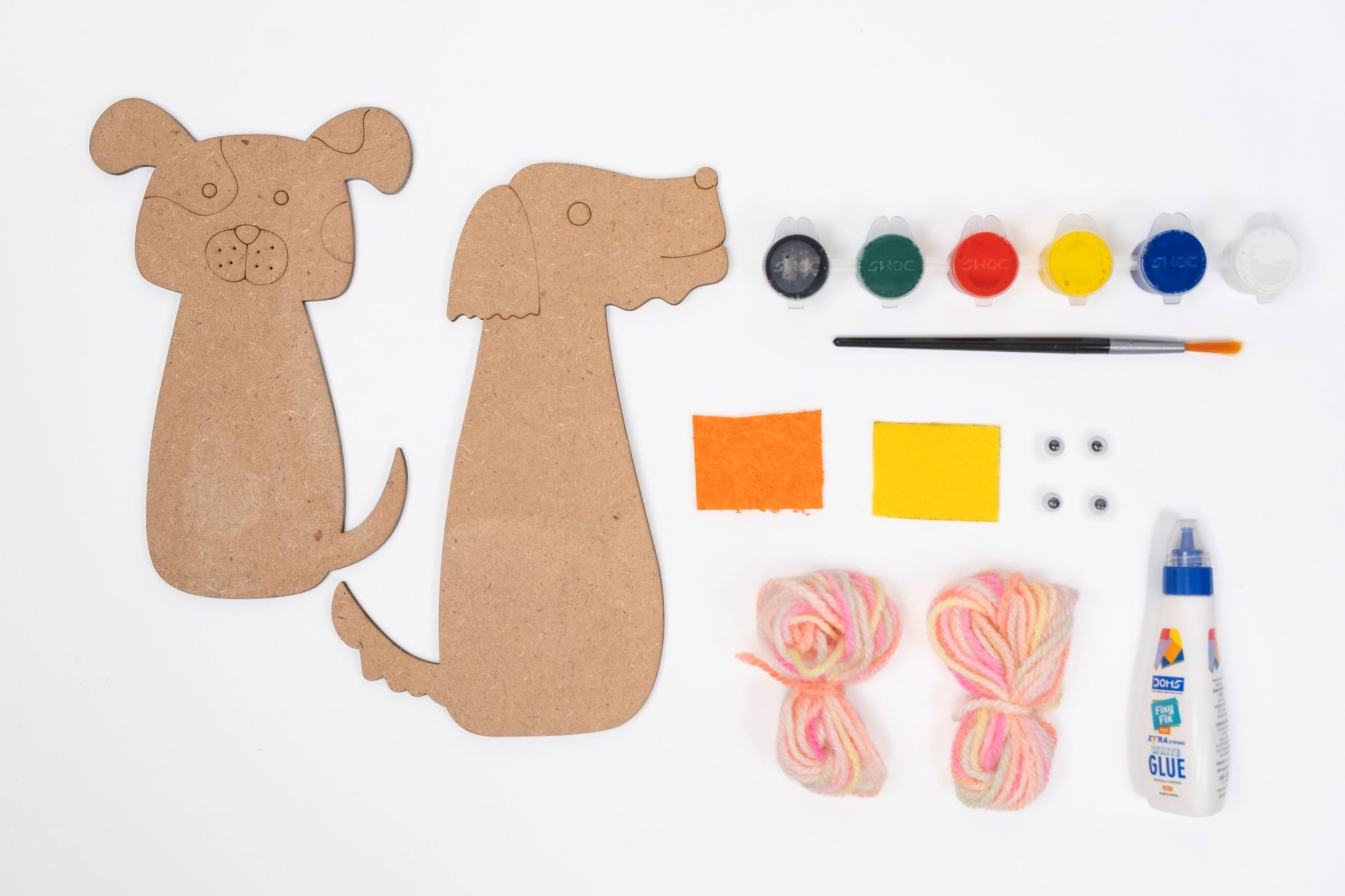 Dog Yarn Craft Kit contents with two MDF dog cut-outs, acrylic paint pots, paint brush, colourful yarn, glue, felt pieces and googly eyes arranged on a white background.