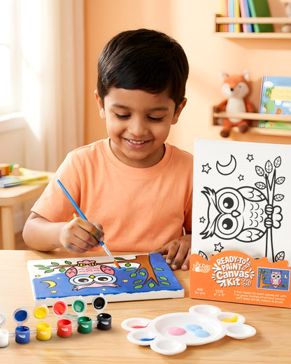 Child painting the Owl Ready-to-Paint Canvas Kit 6×9 using acrylic paints to create a colourful owl sitting on a tree branch under the moon and stars.