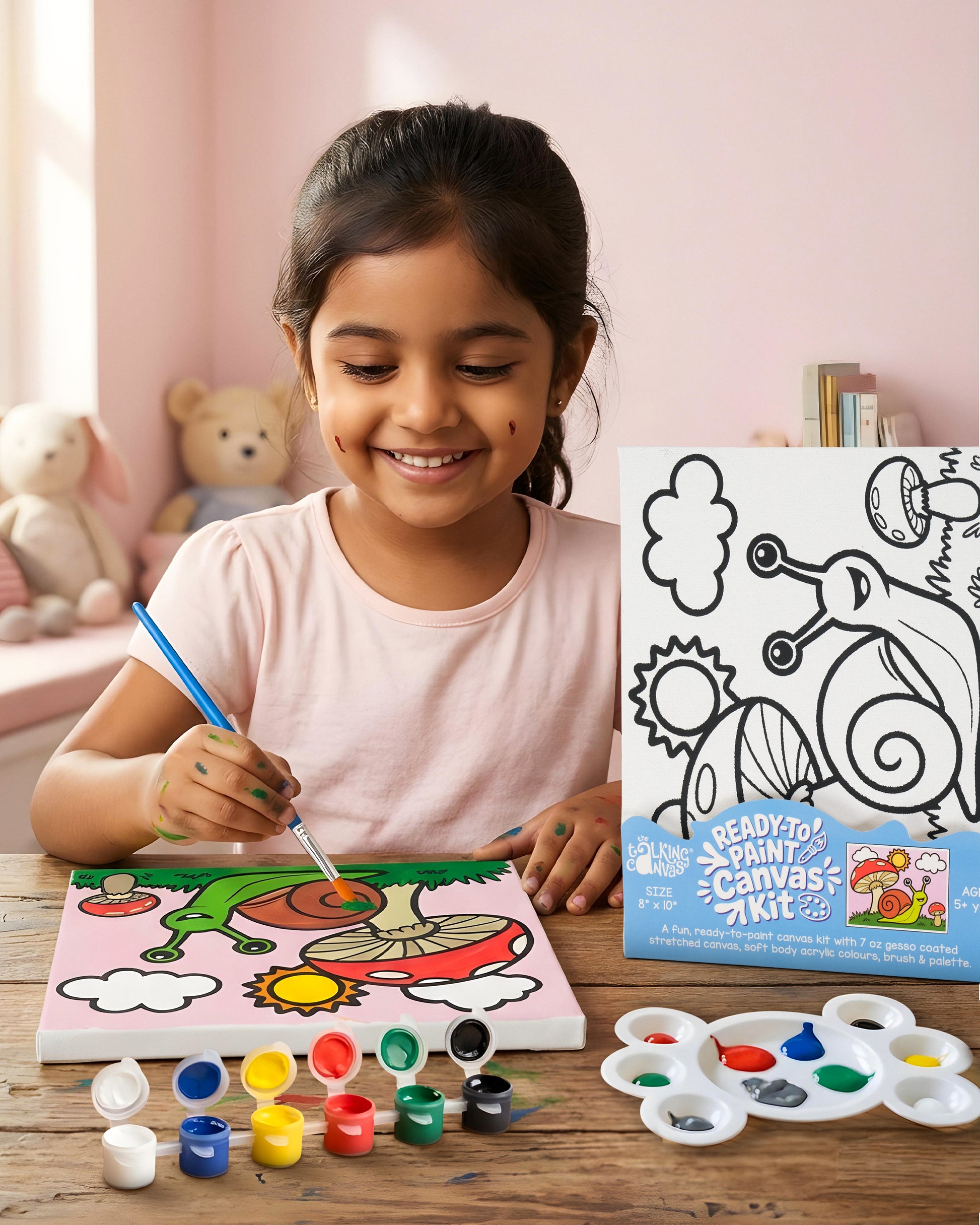 Child creating the Ready-to-Paint Canvas Kit – Snail 8×10 with acrylic paints, brush and completed cheerful snail canvas artwork.