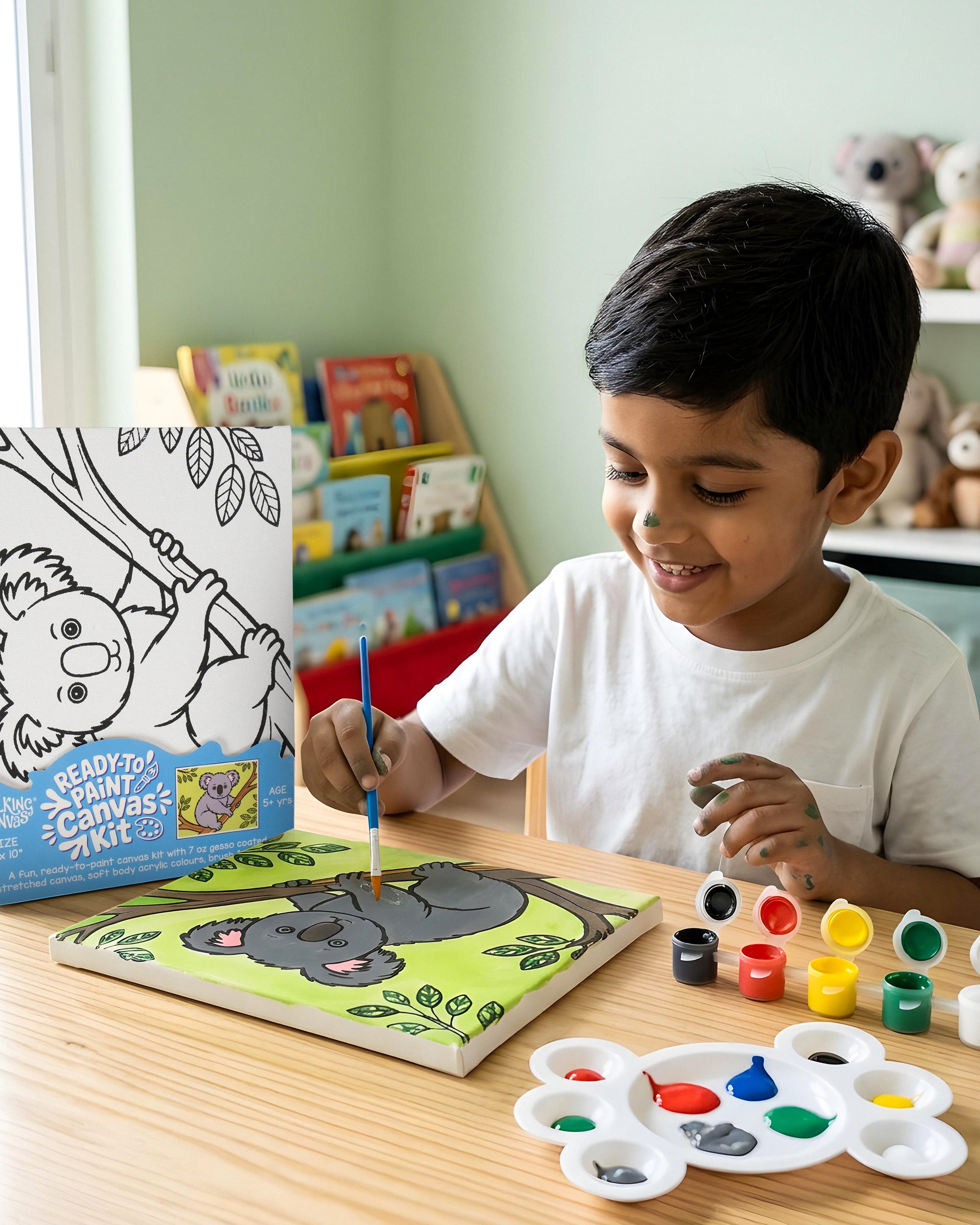 Child enjoying the Ready-to-Paint Canvas Kit – Koala Bear 8×10 with acrylic paints, brush and finished colourful koala canvas artwork.