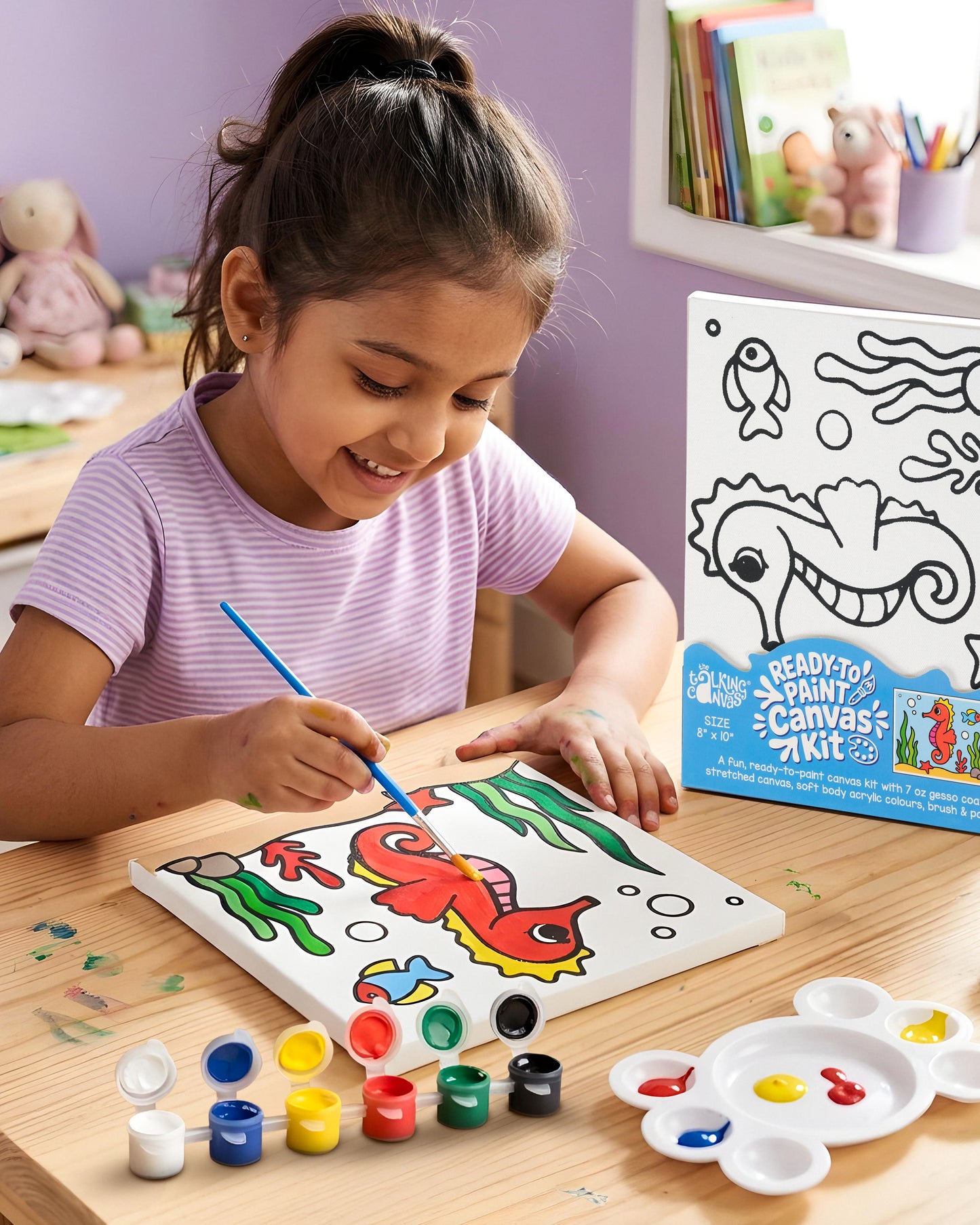 Child painting the Seahorse Ready-to-Paint Canvas Kit 8×10 using acrylic paints to create a colourful underwater seahorse artwork.