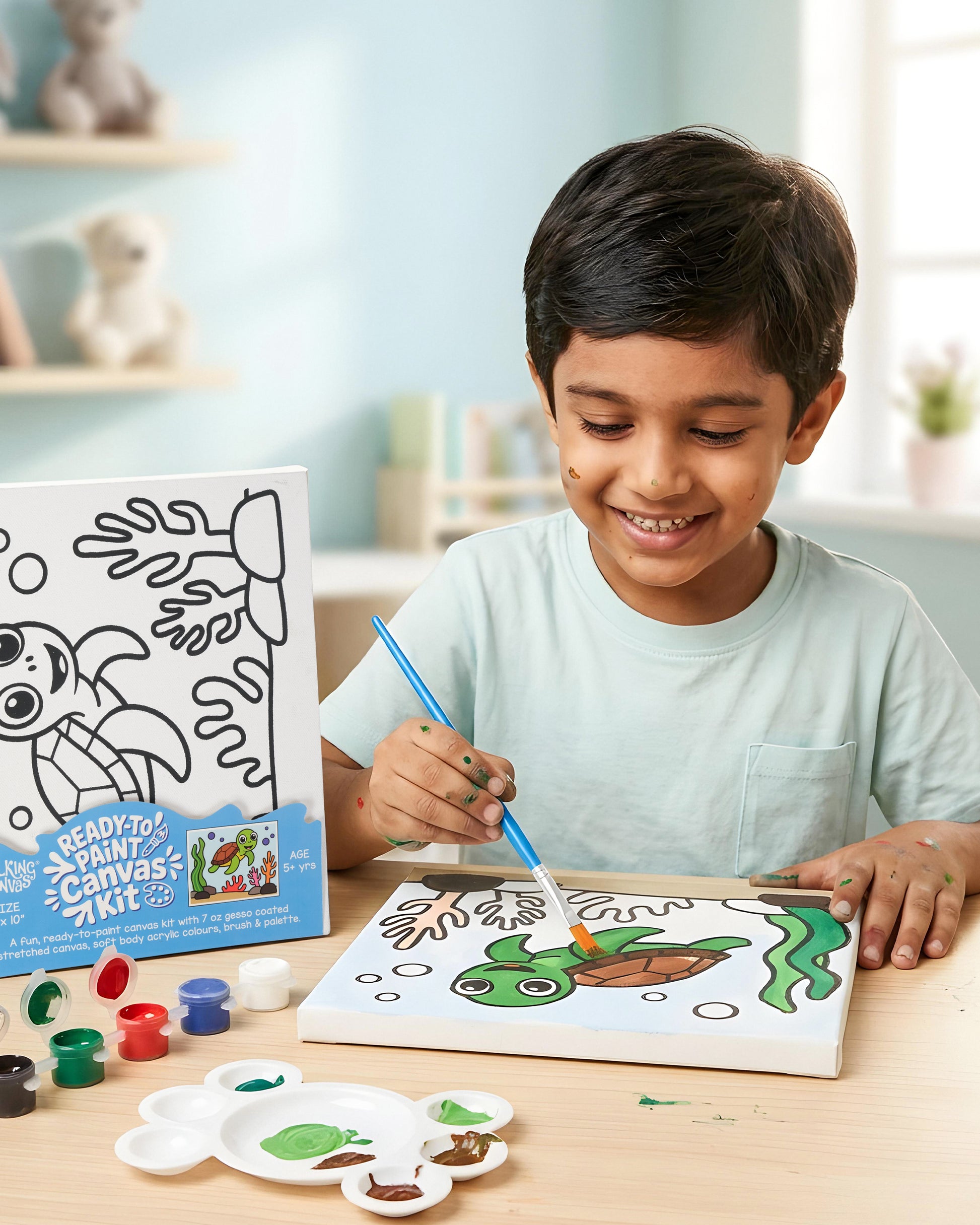 Child painting the Ready-to-Paint Canvas Kit – Tortoise 8×10 using acrylic paints and brush with completed colourful tortoise artwork displayed.