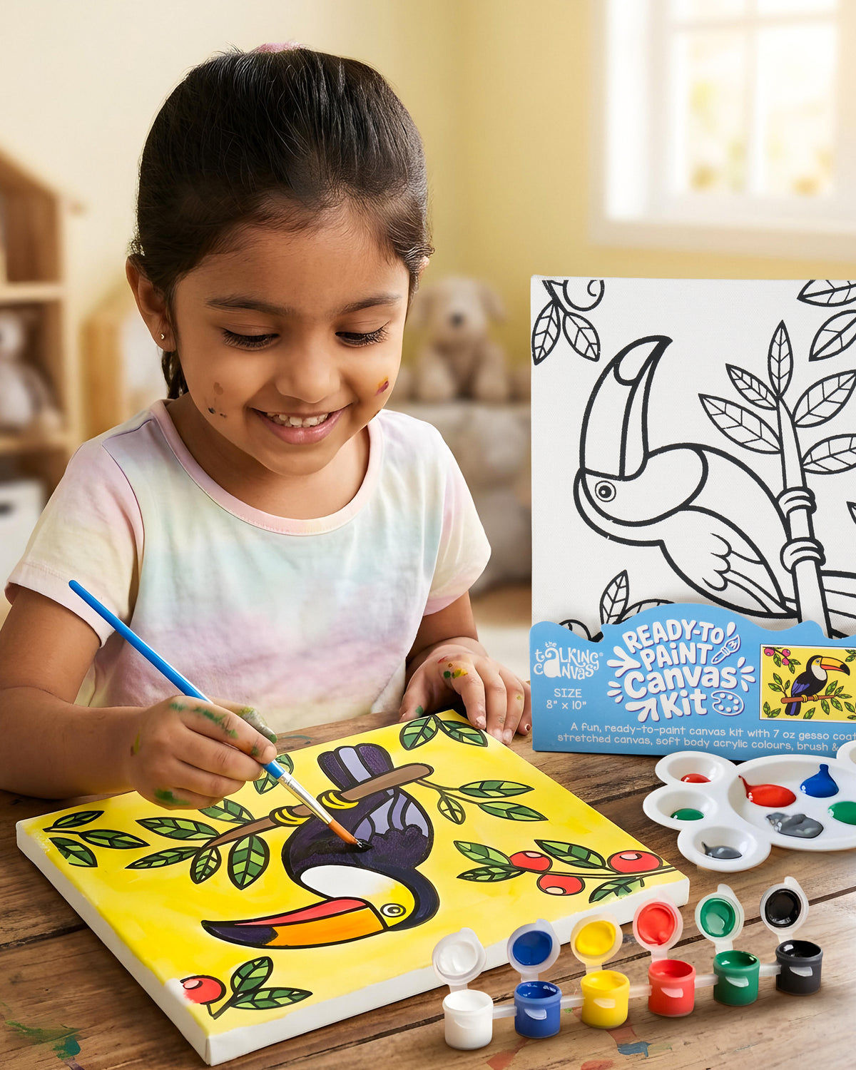 Child painting the Parrot Ready-to-Paint Canvas Kit 8×10 using acrylic paints to create a colourful tropical parrot artwork on canvas.
