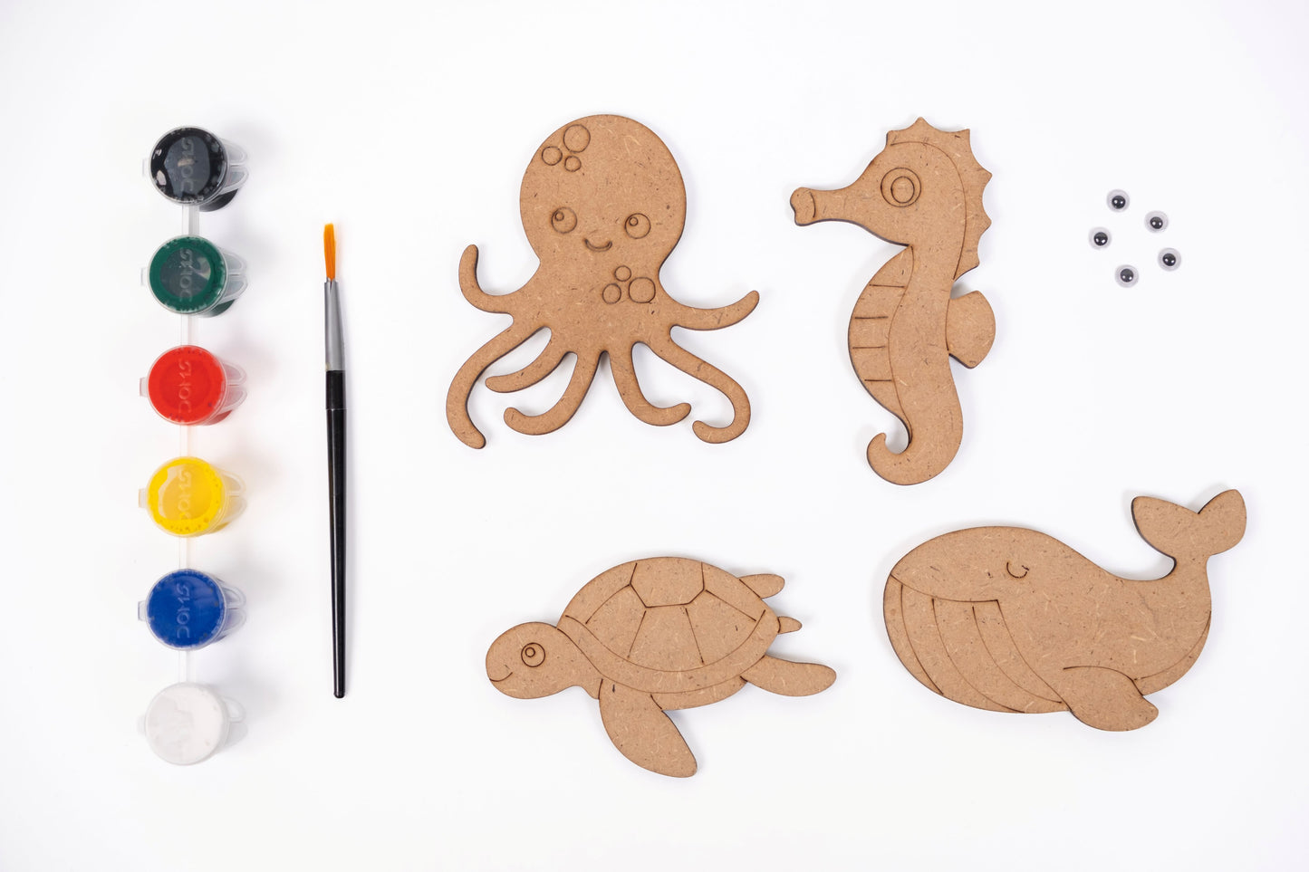 Ocean Magnets DIY Kit contents with four MDF ocean magnet shapes, six acrylic paint pots, paint brush and five googly eyes on a white background.