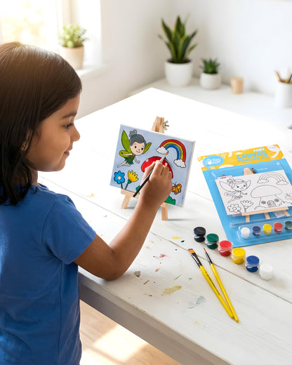 Child painting the Fairy Canvas Painting Kit on a wooden easel using colourful acrylic paints to create a magical fairy scene during a fun screen-free activity.