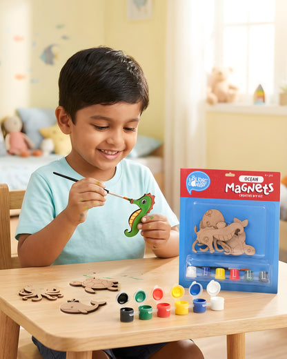 Child painting a seahorse wooden magnet from the Ocean Magnets Creative DIY Kit using acrylic paints during a fun screen-free craft activity.