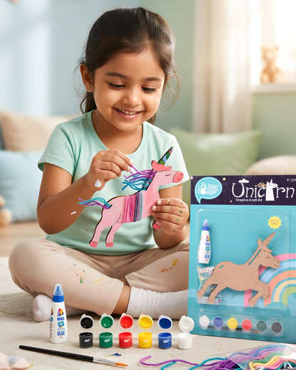 Child creating The Talking Canvas Unicorn Creative Craft Kit using paints, yarn, glue and sequins to decorate the MDF unicorn craft.