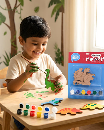 Child painting dinosaur wooden magnets from the Dinosaur Magnets Creative DIY Kit using acrylic paints and brush during a fun screen-free craft activity.