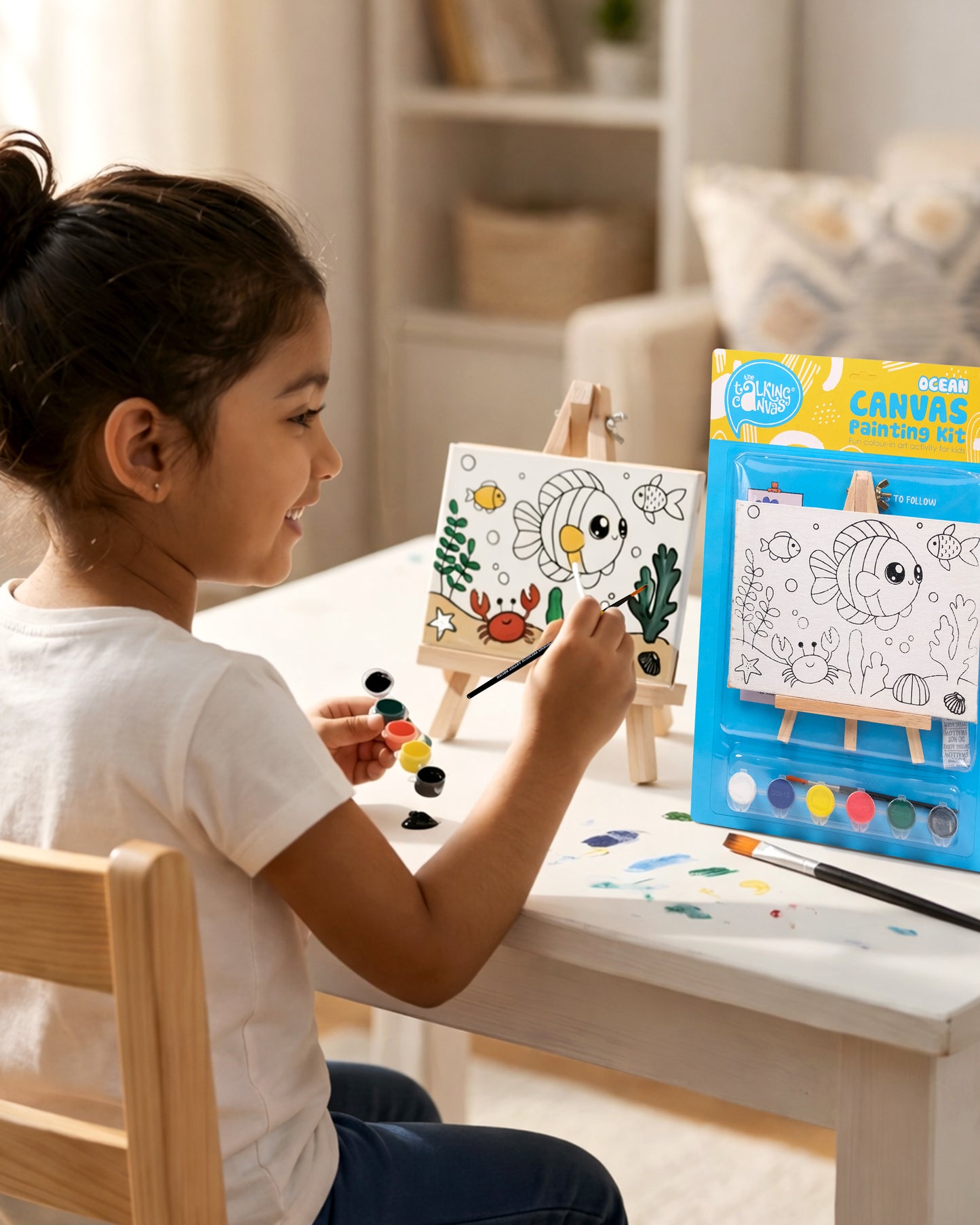 Child painting the Ocean Canvas Painting Kit on a wooden easel using colourful acrylic paints to create a fun underwater scene during a screen-free art activity
