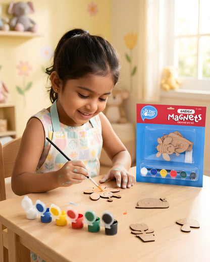 Child painting garden-themed wooden magnets from the Garden Magnets Creative DIY Kit using acrylic paints and brush during a fun screen-free craft activity.